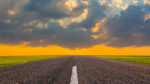 Asphalt road among green fields at the sunset Stock Footage 241501334