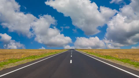 Asphalt road among a green fields time lapse scene Stock Footage 308380791
