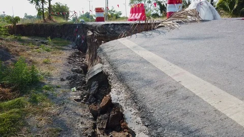 Asphalt road collapsed and fallen. Road collapses with huge cracks. Stock Footage 125288898