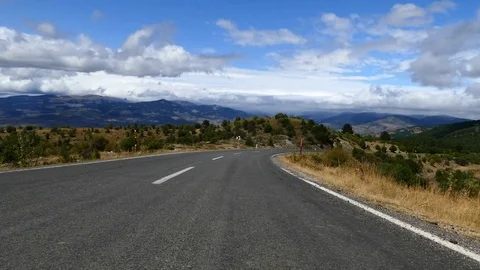 Asphalt road in forested area, clouds and trees, wonderful nature landscape, 库存影片 114714461