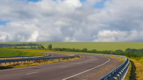 Asphalt road leaving far under cloudy sky Stock Footage 324904872