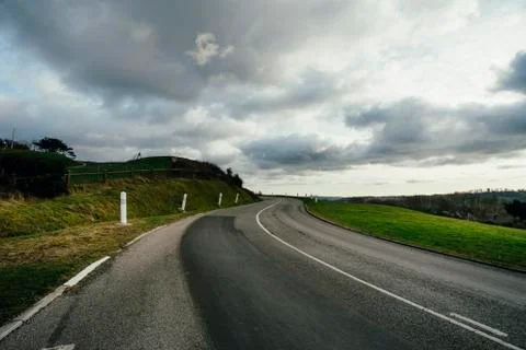 Asphalt road passing through the fields in the region of Normandy, France Stock Photos