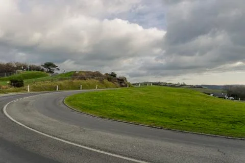 Asphalt road passing through the fields in the region of Normandy, France Stock Photos