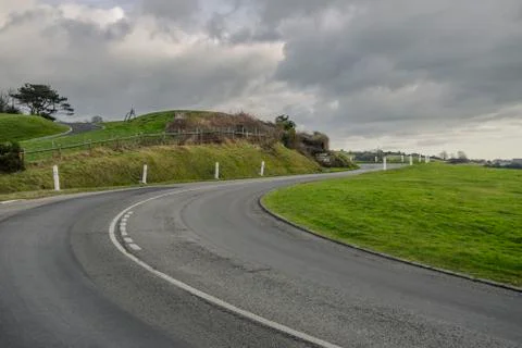 Asphalt road passing through the fields in the region of Normandy, France Stock Photos