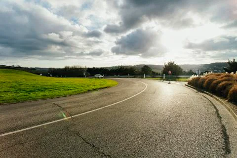 Asphalt road passing through the fields in the region of Normandy, France Stock Photos