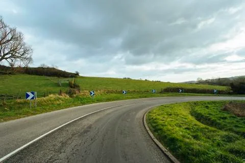 Asphalt road passing through the fields in the region of Normandy, France 스톡 사진