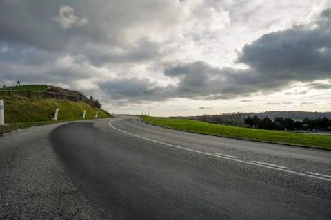 Asphalt road passing through the fields in the region of Normandy, France Stock Photos