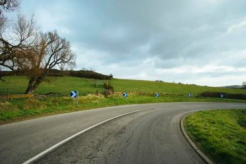 Asphalt road passing through the fields in the region of Normandy, France 스톡 사진