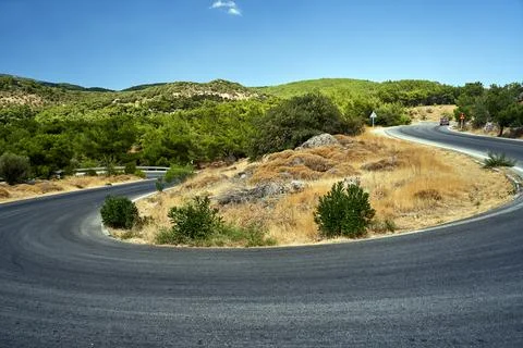 Asphalt road with sharp turns in the mountains on the island of Lesbos Stock-Fotos