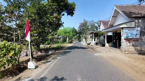 Asphalt road stretches through quiet village streets Stock Footage 345199853