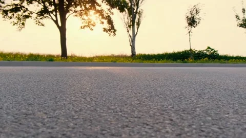 Asphalt road at sunset. Close-up. Video stock 254191340