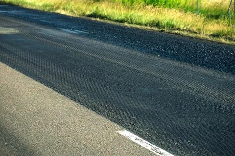 Asphalt road surface texture with sunlight shadow photo Stock Photos