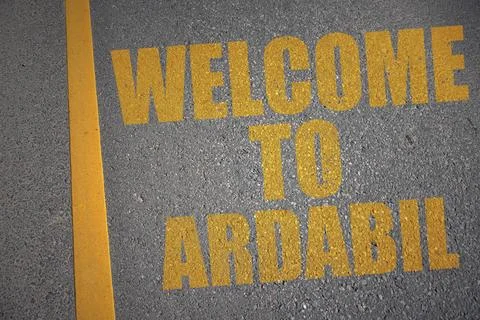 Asphalt road with text welcome to Ardabil near yellow line. Stock Photos