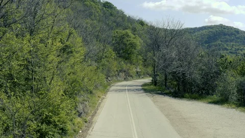 Asphalt road through the forest - drone moving shot Видео 129068248