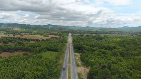 Asphalt road through mountain and forest Stock Footage 90927923