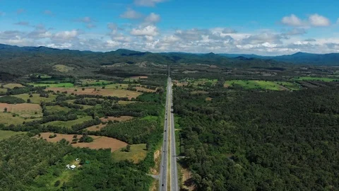 Asphalt road through mountain and forest Stock Footage 95940514