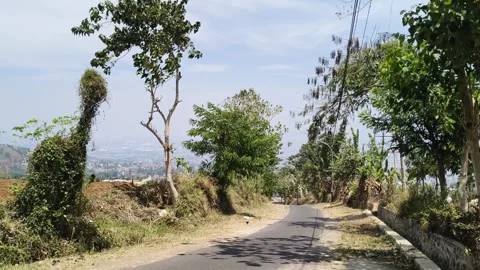 Asphalt road through rural hillside countryside Stock Footage 346660070