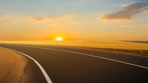Asphalt road turn among a fields at the sunset Video stock 141214330