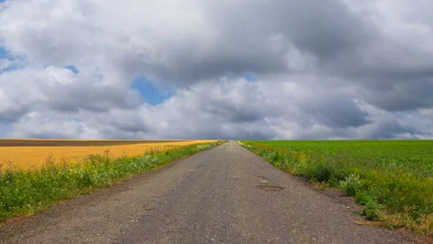 Asphalt road under a dense clouds time lapse scene Stock-Footage 303585594