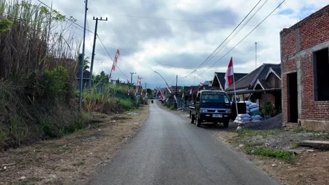 Asphalt road winds through modest village homes Stock Footage 345202715