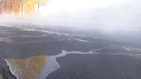 Asphalt roller that stack and press hot asphalt. On hot asphalt water Video stock 104942955