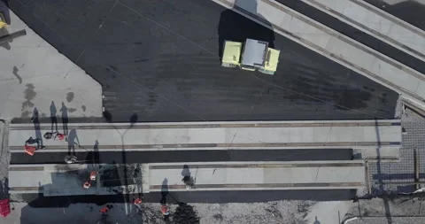 Asphalt spreading machine and vibration roller at pavement road works aerial Stock Footage 131039188