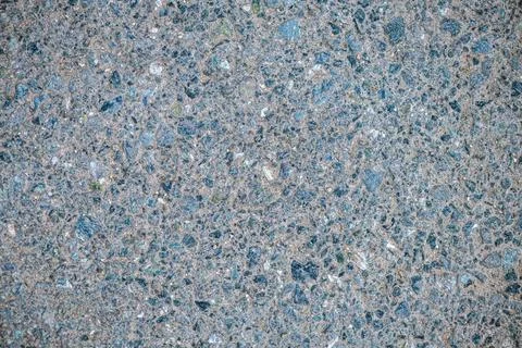 Asphalt surface showing numerous small gray and black stones embedded in a ro Fotos Stock