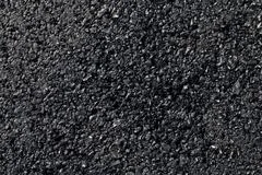 The texture of the background of stone black gray asphalt road