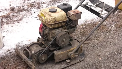 Asphalt vibratory plate compactor. Pothole repair process Stock Footage 237213331