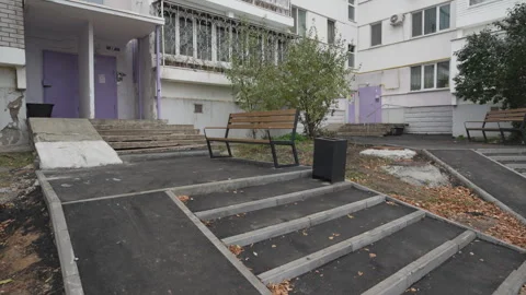 Asphalted courtyard rests between residential buildings Stock Footage 308959116
