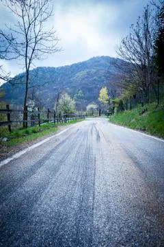 Asphalted mountain road on a spring day Stock Photos