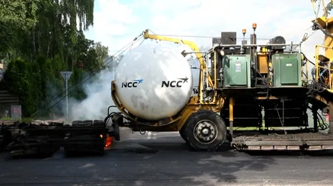 An asphaltmachine working on a road Stock Footage 8536771