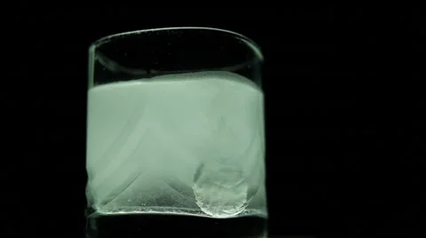 Aspirin or effervescent pill dropping into a glass of water Stock Footage 63225822
