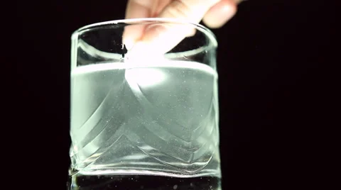 Aspirin or effervescent pill dropping into a glass of water Stock Footage 63225929