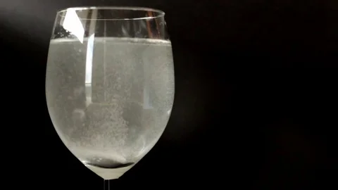 Aspirin tablet dissolving in water Stock Footage 70420049
