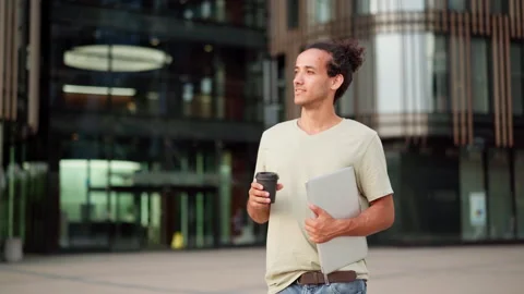 Aspiring young man thinking or day dreaming in city street Stock Footage 158070840