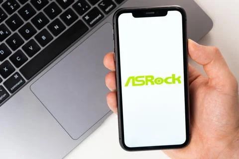 ASRock mobile application on the smartphone screen. Make purchases while sitting Stock Photos