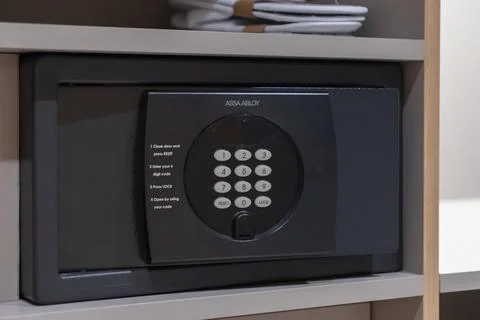 Assa Abloy electronic safe with keypad placed inside a hotel room closet for Stock Photos
