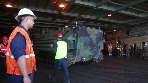 Assault amphibious vehicle tracking onto deck USNS Lummus Stock Footage 90417544