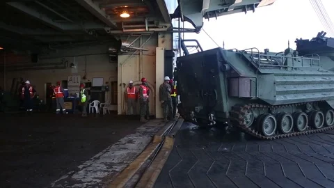 Assault amphibious vehicle tracking onto deck USNS Lummus Stock Footage 90417581
