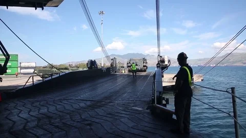 Assault amphibious vehicle tracking up loading ramp of USNS Lummus Stock Footage 90417568