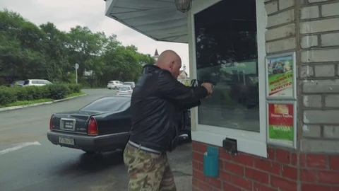Assault of a man with a gun Stock Footage 107091569
