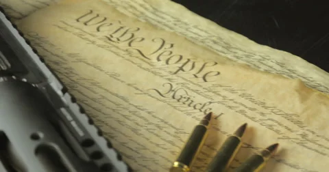 Assault Rifle with the US Constitution and Ammunition Stock Footage 61279561