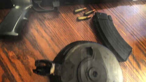 Assault rifles drum and reg mag and body armor with grunge overlay elements  Stock Footage 201693423