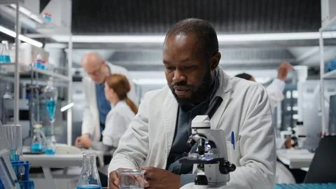 Assay development expert pipetting reactant into solution for purity analysis Stock Photos