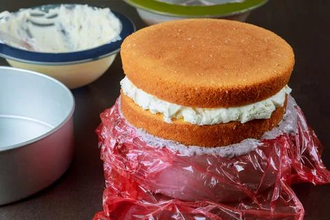 Assemble cake in round baking dish. Stock Photos
