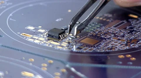 Assemble circuit with surface mount IC's, resistors &amp; caps, by hand Stock Footage 10588945