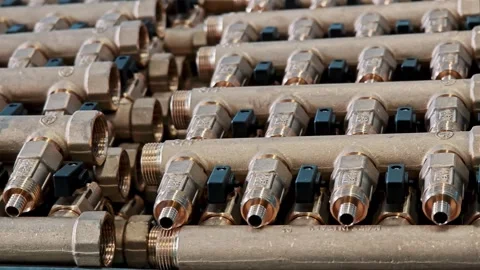 Assembled brass distribution manifolds for heating systems. Mass factory Stock Footage 329289667