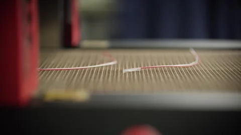 Assembled temperature sensors are conveyed into a curing oven Stock Footage 328830236