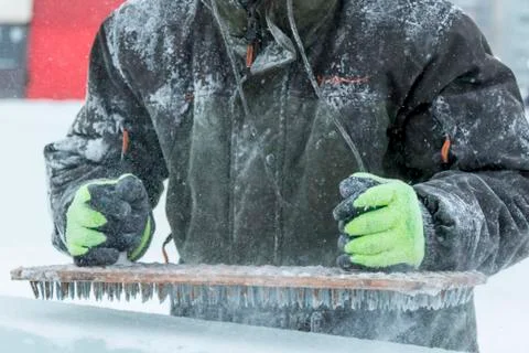 Assembler at the construction site with a brush in his hands 写真素材